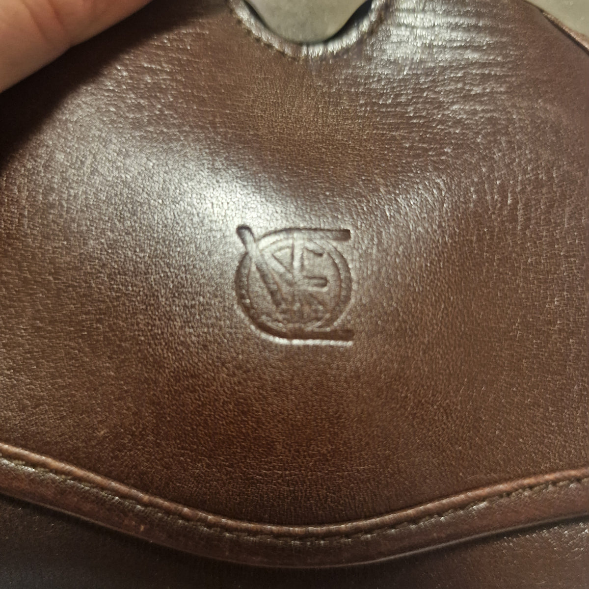 Close-up of a round emblem embossed in brown leather