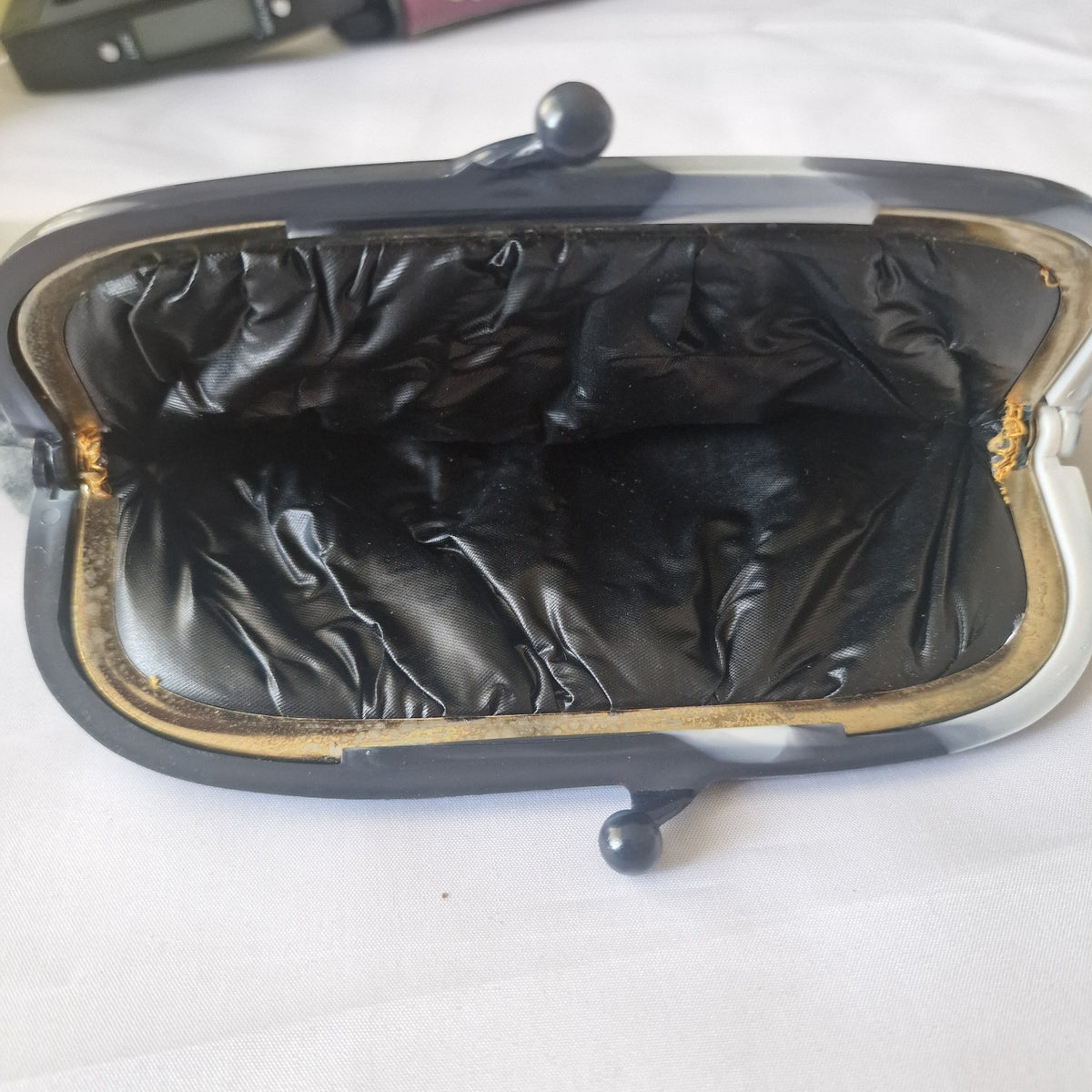 Black satin-look interior of vintage evening clutch