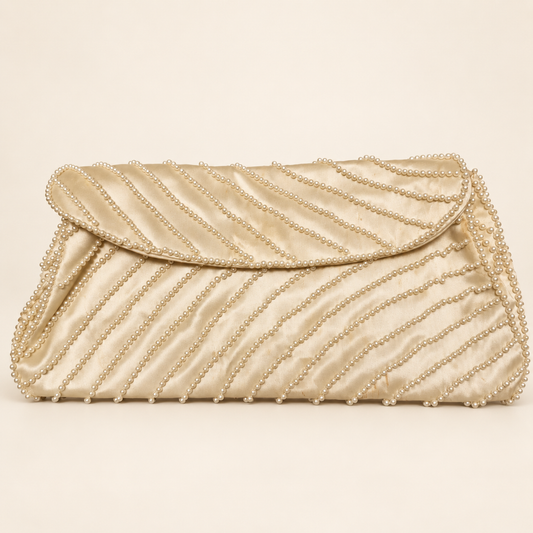 Cream satin-like evening clutch with diagonal faux-pearl rows, shown closed from the front