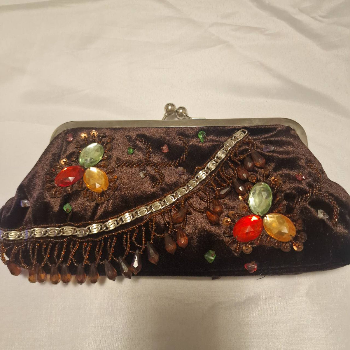 Detailed front view of the brown velvet bag showing beaded flowers, hanging bead fringe and silver-tone chain