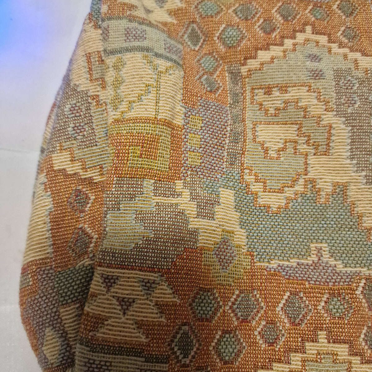 Close-up of the woven geometric tapestry fabric at the lower edge of the bag