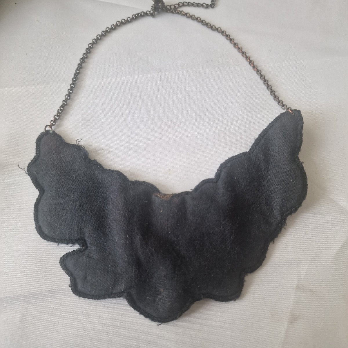 Back view of black textile bib statement necklace