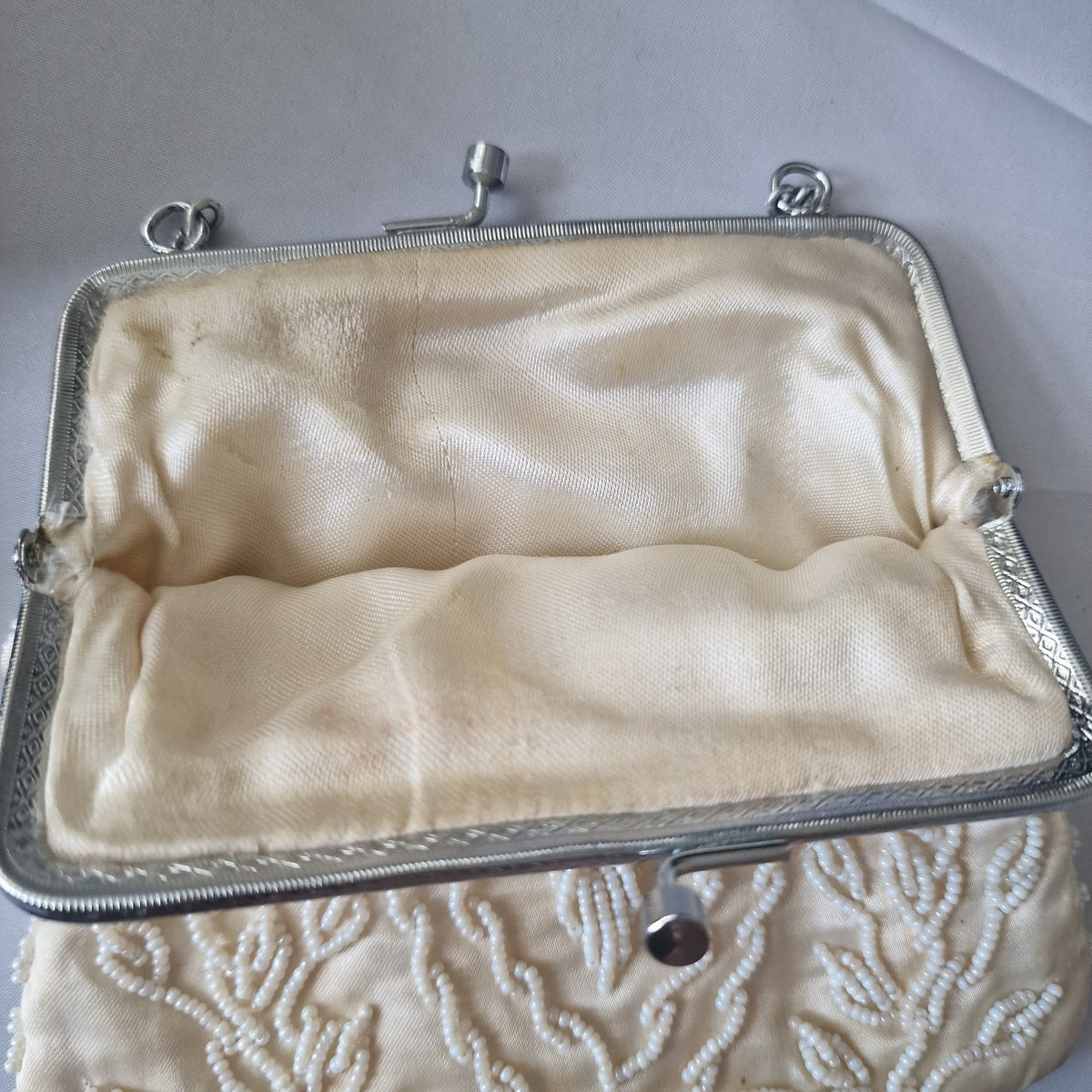 Cream fabric lining inside the vintage beaded evening handbag